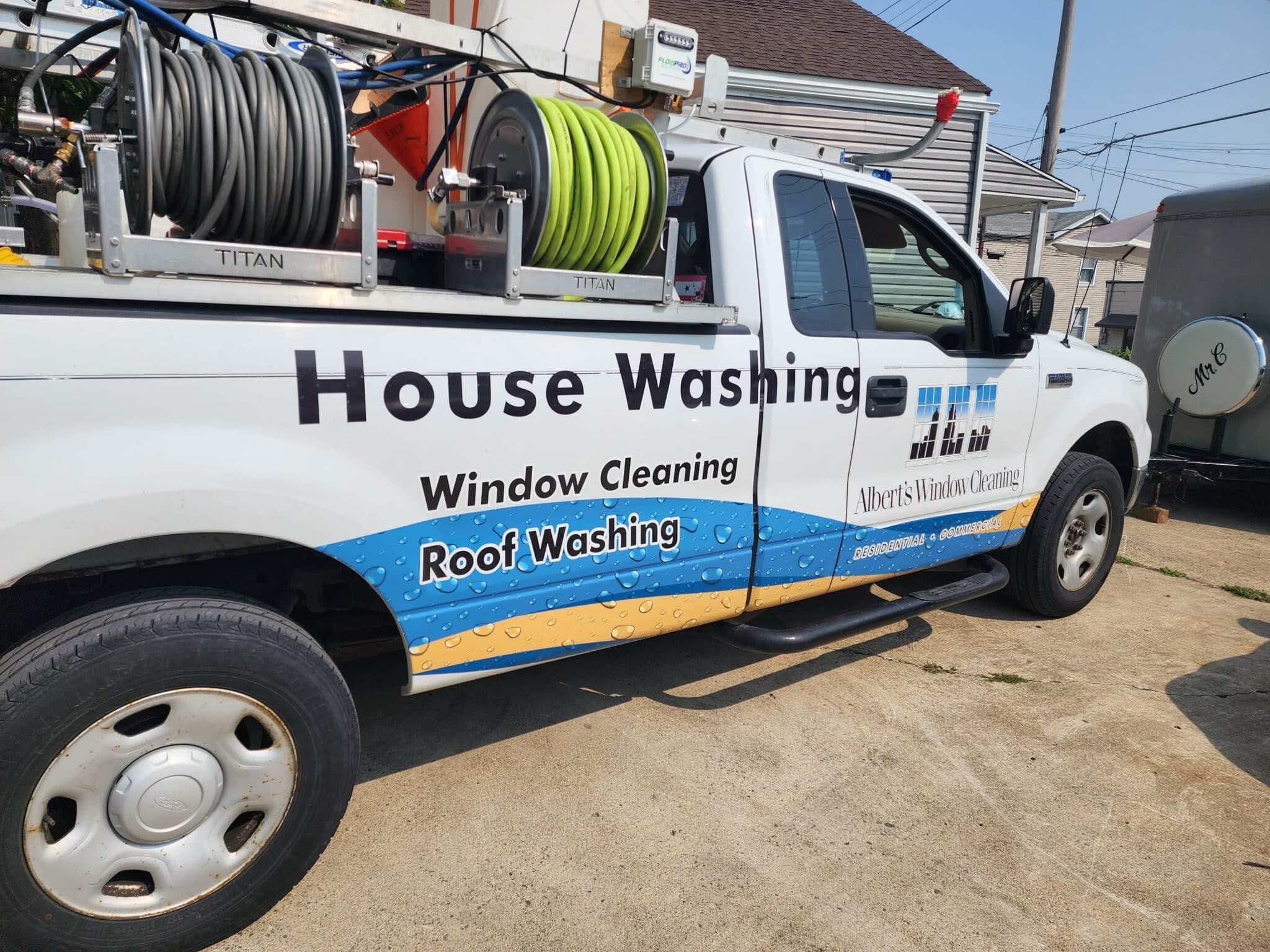 20230819_110854-1-scaled work-truck-with-logo-alberts-window-cleaning-loaded-with-hoses-on-racks-for-exterior-cleaning-services