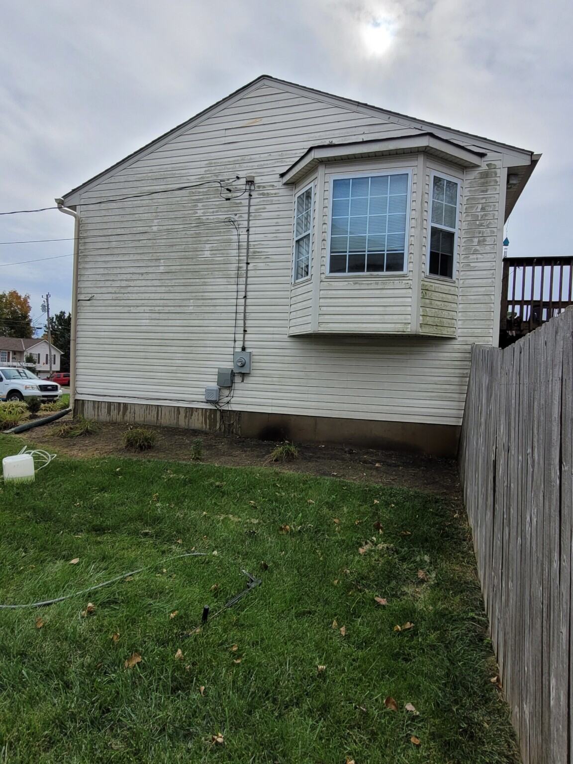 Before soft washing - algae and organic growth on house siding